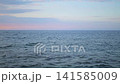 Tranquil Ocean Waters Under Peaceful Dawn Sky 141585009
