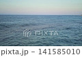 Gentle Ocean Waves Under Clear Blue Sky 141585010