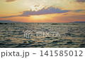 Breathtaking Ocean Sunset With Golden Sky Over Gently Rippling Water 141585012