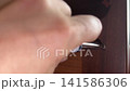 Close up of hand tightening a screw with a screwdriver in wooden furniture 141586306
