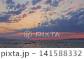 Vibrant Sunset Over Calm Sea With Colorful Clouds 141588332