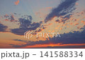 Colorful Sunset Sky With Vibrant Clouds Moving Across Horizon 141588334