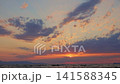 Vibrant Sunset Over Ocean with Colorful Clouds 141588345
