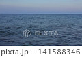 Calm Evening Ocean Waves, Distant Sailboat Horizon 141588346