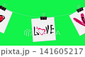 Loopable animation of hand-drawn grunge red black hearts 'Kiss' 'Love' text. Drawn on white papers hanging with binder clips on rope on chroma key green. Ideal for Valentine, romantic or punk designs 141605217