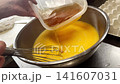 Adding dashi stock to beaten eggs to make dashi-maki tamago (rolled omelet). 141607031