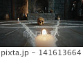 A skull on chalk exorcism pentagram ritual circle. Candle flames on stone floor. 141613664