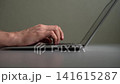 Hands of businessman or programmer typing code on laptop keyboard. Concept of concept of remote work, freelancing, online education, writing important email from home office. Shooting in slow motion. 141615287