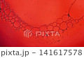 Oil bubbles moving slowly in a red liquid creating a dynamic abstract background 141617578