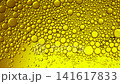 Abstract macro shot of golden oil bubbles moving slowly in a bright yellow liquid background 141617833