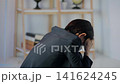 A middle-aged woman is depressed in a dark room. Worries, anxieties, worries, stress, depression, despair, mental health, regret, failure 141624245