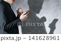 A man using a smartphone and his silhouette. Keywords: SNS, app, email, video, serious, anxiety, worry, fraud. 141628961