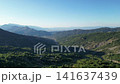 Panoramic aerial view of deep green mountain valley stretching towards distant horizon in Pindus range Thessaly Greece for outdoor nature travel video background 141637439