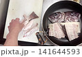 Arranging sea bream bones in a pot; preparing for simmered sea bream bones. 141644593