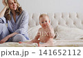 Baby and mother enjoy time together at home 141652112