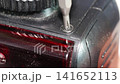 Repairing electronic parts with precision tools in workshop 141652113