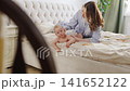Mother and baby share moments of fun at home in the morning 141652122