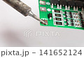 Repairing electronics with soldering skills at a workshop 141652124