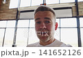 Men blogger shares thoughts in modern cafe setting with large windows 141652126