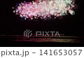 The grand finale of Japan's colorful, ever-changing starburst fireworks illuminating the night sea. 141653057