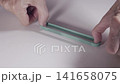 Detail of green elastic rubber band 141658075