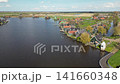 Windmills and wooden houses in Zaanse Schans heritage park in Netherlands 141660348