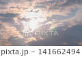 Timelapse: setting sun hiding behind fast clouds with lens flare 141662494