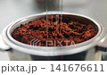 Tool with needles aerating coffee grounds in portafilter 141676611