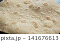 Wheat flatbread puffing up on hot skillet 141676613