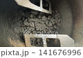 Inside a concrete mixer drum rotating blades and centrifuge action 141676996
