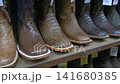 Display of various Cowboy boots. 141680385