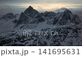 Aerial view of jagged snow mountain peak at dusk 141695631