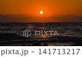 Orange Sun Setting on the Sea Horizon with Dark Mountains Silhouette. Amazing Cinematic Landscape 141713217