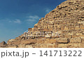 Close Up tilt shot along the Corner Edge of the Pyramid of Khafre with Pyramid of Menkaure in Background at Giza Necropolis 141713222