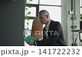 Mature businessman search in office, footage. Business boss man. Business success. Successful business. Entrepreneur searching for notes. Office manager man. Businessman in suit look for notes 141722232