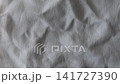 Static closeup of wrinkled white linen fabric with visible woven fibers. Natural textile background ideal for minimalist, organic, product mockups and interior design concepts. 141727390