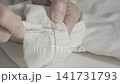 Seamstress at work with seam ripper 141731793