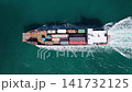 Commercial shipping. Cargo ship in sea, aerial view. Freight container loaded on cargo vessel. Aerial view cargo ship entering harbor. Cargo business delivery. Container ship. Shipping logistics 141732125