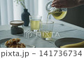 Table setting: Green tea poured into a glass. 141736734