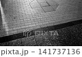 A monochrome silhouette of a person walking, in slow motion. 141737136