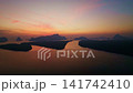 Colorful sunset or sunrise above the sea surface,Aerial view drone fly over open sea,Reflected sun beautiful light of nature on water surface,Sunset over ocean,Sea summer and travel vacation concept 141742410