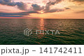 Colorful sunset or sunrise above the sea surface,Aerial view drone fly over open sea,Reflected sun beautiful light of nature on water surface,Sunset over ocean,Sea summer and travel vacation concept 141742411