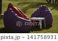 Upholstered seats located in the park recreation area 141758931