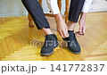Business, hands and tie shoes in home on bed with getting ready, dressing for work or morning routine in bedroom. Professional, man and employee with designer footwear in apartment for startup career 141772837