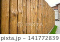 Vertical wooden planks create a rhythmic pattern, emphasizing natural texture and symmetry, perfect for modern architectural backgrounds. 141772839