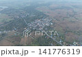 High altitude drone footage shows a network of rural villages linked by roads in Nong Bua Lamphu. The wide panorama highlights spatial connections across the countryside. 141776319
