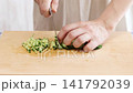 The process of julienning a cucumber. 141792039