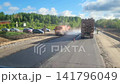 Road repair. We pass a large number of construction vehicles laying asphalt. 141796049