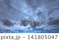 The cloudy sky above and the blue sky in the distance 141805047