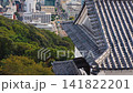 Japanese Castle Roof Architecture Aerial View 4k Drone Shot Overlooking Urban Cityscape and Distant Mountains with Traditional Tiled Eaves and Ornate Decorative Ornament 141822201